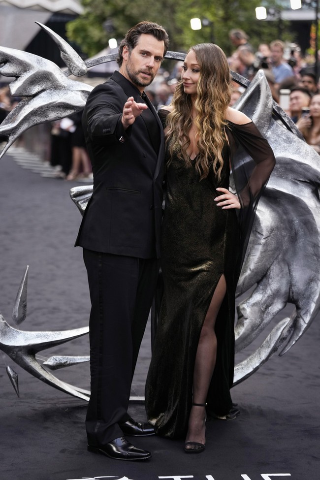 Senada dengan Henry, wanita asal New Mexico, AS, itu mengandalkan gaun hitam yang hadir dengan belahan tinggi pada bagian rok. Saat berpose di hadapan fotografer, sejoli ini pun tak ragu untuk memamerkan kemesraan. (Foto: Scott Garfitt/Invision/AP)