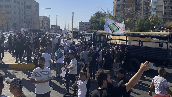 Hundreds of followers of the influential Iraqi Shiite cleric and political leader Muqtada Sadr stand outside the Swedish embassy in Baghdad, Iraq, Thursday, June 29, 2023, in protest of the burning of a Quran in Sweden. An Iraqi security official has said the Swedish embassy was evacuated by security forces after the protesters breached the building, raising pictures of Sadr and flags of his militia, the Mahdi Army. (AP Photo/Ali Jabar)