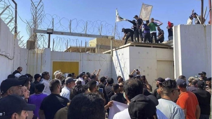 Iraq-Swedish Embassy-Stormed Hundreds of followers of the influential Iraqi Shiite cleric and political leader Muqtada Sadr stand outside the Swedish embassy in Baghdad, Iraq, Thursday, June 29, 2023, in protest of the burning of a Quran in Sweden. An Iraqi security official has said the Swedish embassy was evacuated by security forces after the protesters breached the building, raising pictures of Sadr and flags of his militia, the Mahdi Army. (AP Photo/Ali Jabar)