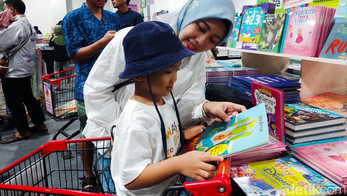 Momen orangtua saat ajak anak liburan sambil baca buku