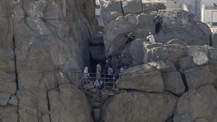 Muslim pilgrims pray at Hira's Cave, where Muhammad, Muslim's prophet, is believed to have received the first verses of the Quran, the Muslim holy book, in the mountains on the edge of Mecca, Saudi Arabia, Friday, June 30, 2023. (AP Photo/Amr Nabil)