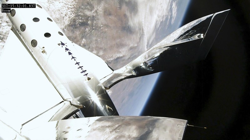 This Thursday, June 29, 2023, image provided by Virgin Galactic show the rocket of the company's spaceplane igniting during a research flight that included Italian specialists who conducted a number of microgravity experiments. With the research flight complete, Virgin Galactic plans to begin commercial flights with paying ticket holders in August. (Virgin Galactic via AP)