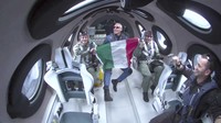 This Thursday, June 29, 2023, image provided by Virgin Galactic show the rocket of the companys spaceplane igniting during a research flight that included Italian specialists who conducted a number of microgravity experiments. With the research flight complete, Virgin Galactic plans to begin commercial flights with paying ticket holders in August. (Virgin Galactic via AP)