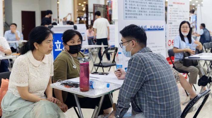 People attend a job fair in a mall in Beijing, China June 30, 2023. REUTERS/Thomas Peter