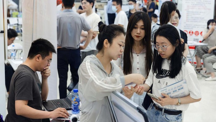 People attend a job fair in a mall in Beijing, China June 30, 2023. REUTERS/Thomas Peter