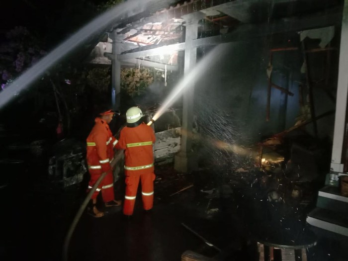 Petugas pemadam kebakaran berusaha memadamkan api yang membakar warung dan garasi warga di Banjar Yehkuning, Desa Pekutatan, Kecamatan Pekutatan, Kabupaten Jembrana, Bali, Sabtu (1/7/2023). (Istimewa)