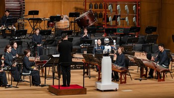Robot ini memandu tiga dari lima bagian orkestra termasuk salah satunya ditemani oleh konduktor asli.