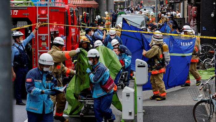 Injured people are transported from the site of an apparent explosion near Shimbashi station in Tokyo, Japan July 3, 2023. REUTERS/Issei Kato