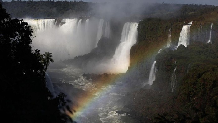 Terpesona Keindahan Air Terjun Iguazu di Brasil Tourists enjoy the Iguazu Falls as they take selfies on an observation platform at the Iguazu National Park near the southern Brazilian city of Foz do Iguacu, in Brazil, July 2, 2023. REUTERS/Agustin Marcarian