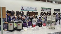 Kedatangan jemaah haji ini disambut oleh PPIH Jakarta. Jemaah haji kemudian berkumpul di Gedung Serbaguna 2 Asrama Haji untuk istirahat sejenak sambil menikmati kudapan. Di sini juga jemaah haji akan diberikan 10 liter air zamzam serta Kartu Kewaspadaan Kesehatan Jemaah Haji (K3JH). Foto: Devi Setya/detikHikmah