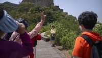 Tak lupa juga warga berswafoto dengan background pemandangan di tembok China.