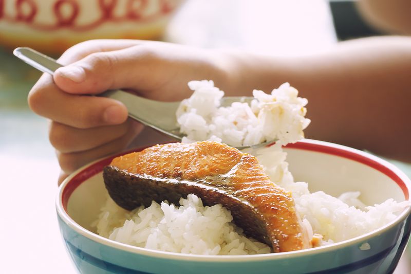 Kid Eating Grill Salmon with Rice