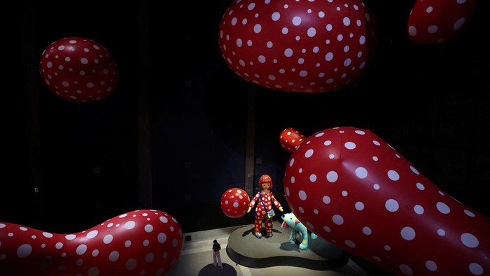 Visitors look at a part of Japanese artist Yayoi Kusama's installation 
