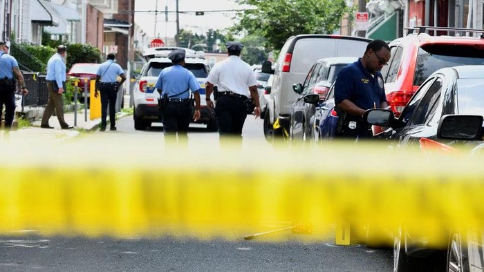 Police officers work at the scene as investigations are ongoing the day after a mass shooting in the Kingsessing section of southwest Philadelphia, Pennsylvania, U.S. July 4, 2023. REUTERS/Bastiaan Slabbers