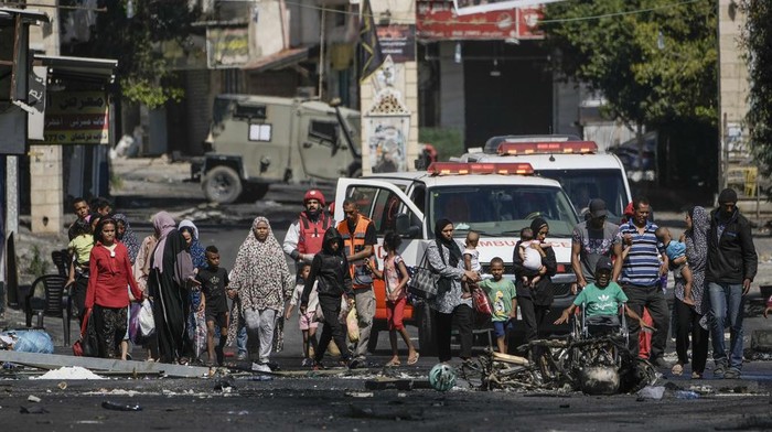 Residents of the Jenin refugee camp fled their homes as the Israeli military pressed ahead with an operation in the area, in Jenin, West Bank, Tuesday, July 4, 2023. Palestinian health officials put the Palestinian death toll from the two-day raid at 10. The Israeli military said Israel launched the operation because some 50 attacks over the past year had emanated from Jenin. (AP Photo/Majdi Mohammed)