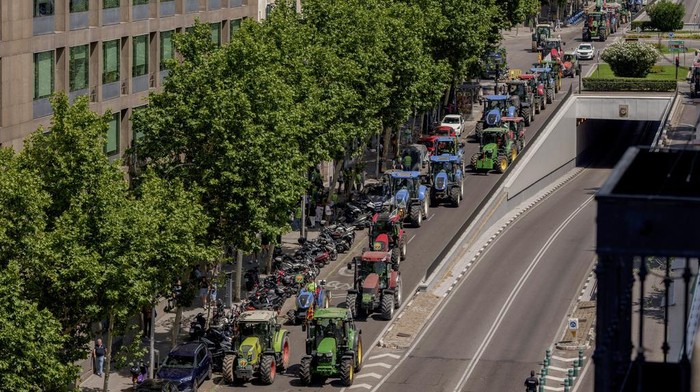 Farmers drive their tractors during a protest on the streets of Madrid, Wednesday, July 5, 2023. Farmers arrive in tractors from around Spain to stage a protest demanding funds to alleviate problems caused by severe drought elevated production costs. (AP Photo/Manu Fernandez)