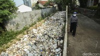 Warga beraktivitas di samping halaman dan kali yang dipenuhi sampah di Balai Kota Depok, Kamis (6/7/2023).