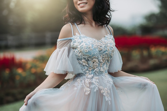 an asian chinese female model dress up with wedding gown for outdoor portrait session at public park in evening