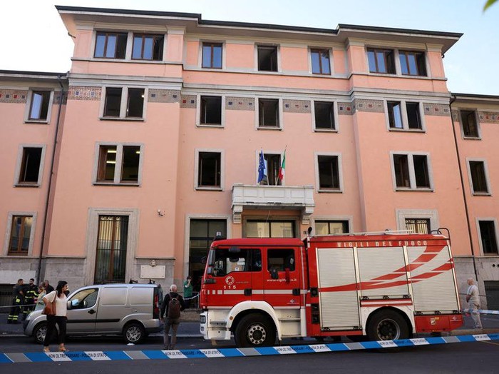 Firefighters work at the scene following a fire in a retirement home in Milan, Italy, July 7, 2023. REUTERS/Claudia Greco