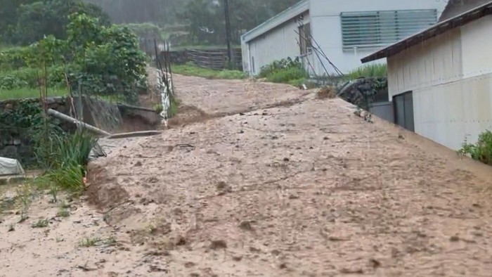 ASIA-WEATHER/JAPAN People make their way in a flooded road in heavy rain in Kurume, Fukuoka Prefecture, Japan July 10, 2023, in this photo taken by Kyodo. Mandatory credit Kyodo via REUTERS ATTENTION EDITORS - THIS IMAGE WAS PROVIDED BY A THIRD PARTY. MANDATORY CREDIT. JAPAN OUT. NO COMMERCIAL OR EDITORIAL SALES IN JAPAN. REFILE - CORRECTING MONTH