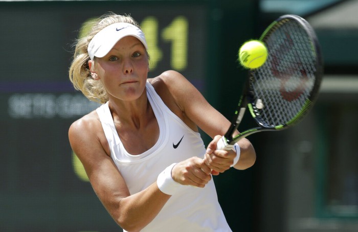 Sofya Zhuk of Russia returns a ball to Anna Blinkova of Russia during the girls' singles final at the All England Lawn Tennis Championships in Wimbledon, London, Saturday, July 11, 2015. (AP Photo/Alastair Grant)
