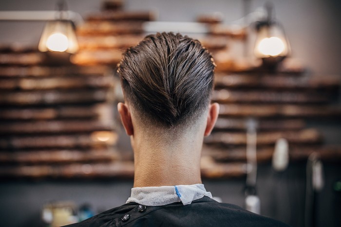 One man, handsome young man with modern haircut at the barber shop.