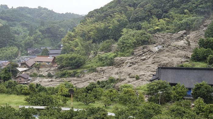Rescuers conduct a search operation for the missing persons at the site of a landslide in Karatsu, Saga prefecture, southern Japan Tuesday, July 11, 2023. Rain falling in the regions of Kyushu and Chugoku since the weekend caused flooding along many rivers, triggered mudslides, closed roads, disrupted trains and cut the water supply in some areas.  (Kyodo News via AP)