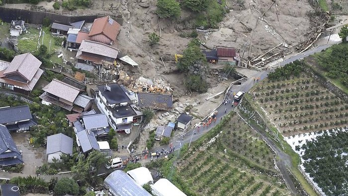 Japan Heavy Rain Rescuers conduct a search operation for the missing persons at the site of a landslide in Karatsu, Saga prefecture, southern Japan Tuesday, July 11, 2023. Rain falling in the regions of Kyushu and Chugoku since the weekend caused flooding along many rivers, triggered mudslides, closed roads, disrupted trains and cut the water supply in some areas. (Kyodo News via AP)