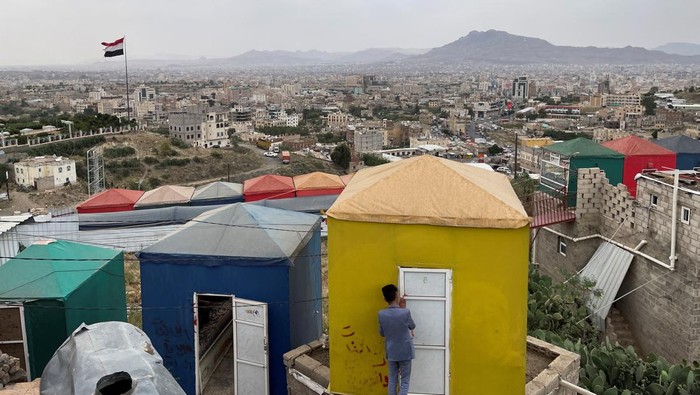 People chew qat, a mild stimulant, as they sit in a hillside area where newly built cabins offer qat chewers the experience of enjoying the cityscape from mountains surrounding the city of Sanaa, Yemen July 6, 2023. REUTERS/Khaled Abdullah