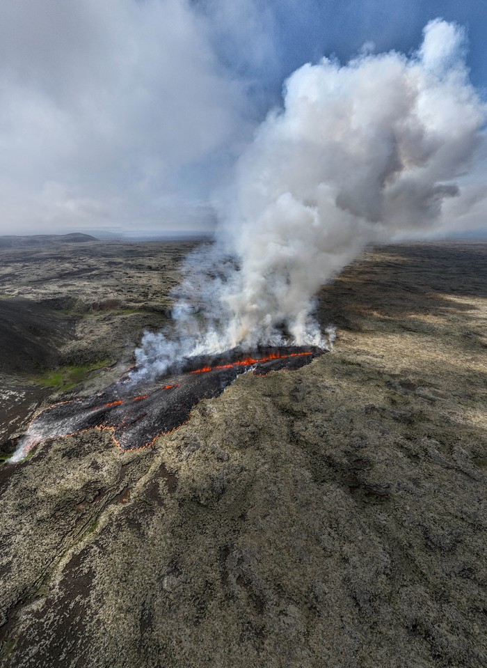 Smoke billows and lava flows after the eruption of a volcano, on the Reykjanes peninsula, near the capital Reykjavik, in southwest Iceland, July 10, 2023, in this picture obtained from social media. Juergen Merz - Glacier Photo Artist/via REUTERS  THIS IMAGE HAS BEEN SUPPLIED BY A THIRD PARTY. MANDATORY CREDIT. NO RESALES. NO ARCHIVES.