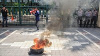 Pendemo berorasi di depan pagar gedung Kemendikbud, Jakarta.  