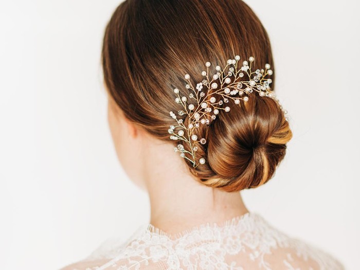 Beautiful female back head with bridal hairdo on white