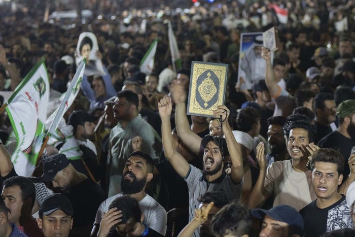 Supporters of Shiite Muslim leader Moqtada Sadr burn rainbow flags, during a demonstration in Sadr City, in response to the burning of Quran in Sweden, Baghdad, Iraq, Wednesday, July 12, 2023. (AP Photo/Hadi Mizban)