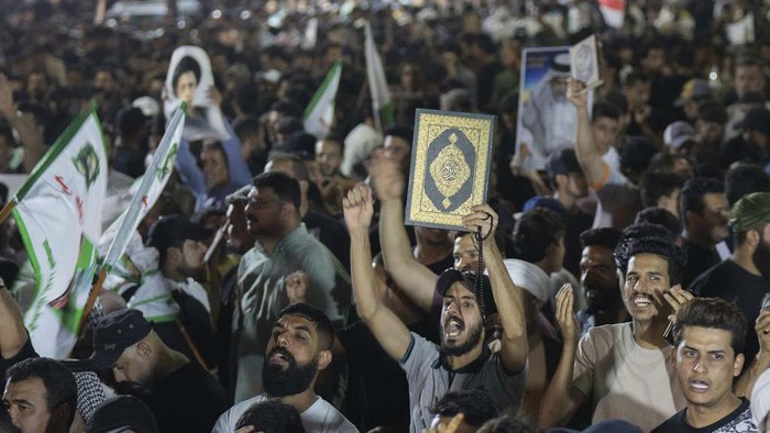 Supporters of Shiite Muslim leader Moqtada Sadr burn rainbow flags, during a demonstration in Sadr City, in response to the burning of Quran in Sweden, Baghdad, Iraq, Wednesday, July 12, 2023. (AP Photo/Hadi Mizban)
