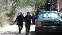 Petugas gabungan yang terdiri dari tentara dan polisi melakukan penjagaan di lokasi serangan bom rakitan yang menewaskan enam orang anggota polisi di Tlajomulco de Zuniga, Meksiko, Rabu (12/7/2023).