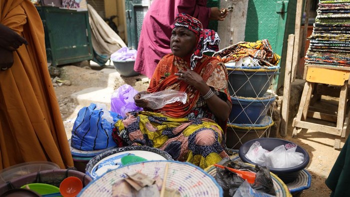 People shop at a market in Kano, Nigeria, Thursday, July 13, 2023. Nigeria's President Bola Tinubu has announced his government's plan to pay $10 monthly to poor households to ease the growing hardship caused by the scrapping of subsidies that had reduced the cost of gasoline. (AP Photo/Sunday Alamba)