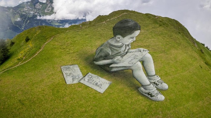 SWISS-ART/ A land art painting representing a child drawing by Swiss-French artist SAYPE is pictured at the Chamossiare in Villars-sur-Ollon, Switzerland, July 13, 2023. REUTERS/Denis Balibouse NO RESALES. NO ARCHIVES