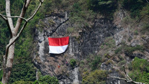 Pegiat panjat tebing membuat jalur pengibaran bendera merah putih di sebuah tebing kawasan lereng Gunung Wilis, Kabupaten Madiun, Jawa Timur, Sabtu (15/7/2023). Jalur tersebut akan digunakan untuk pengibaran Bendera Merah Putih oleh pegiat panjat tebing bersama prajurit TNI pada peringatan HUT ke-78 Proklamasi Kemerdekaan RI 17 Agustus mendatang. ANTARA FOTO/Siswowidodo/nym.