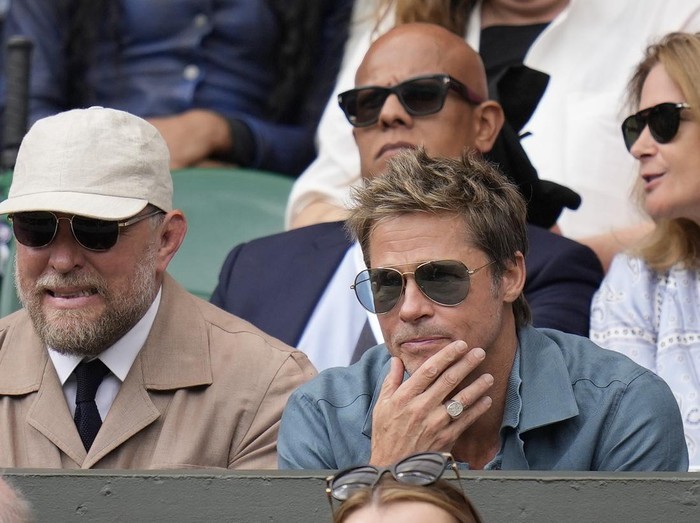 Actor Brad Pitt and director Guy Ritchie sit in the stands on Centre Court for the final of the mens singles between Spains Carlos Alcaraz and Serbias Novak Djokovic on day fourteen of the Wimbledon tennis championships in London, Sunday, July 16, 2023. (AP Photo/Kirsty Wigglesworth)