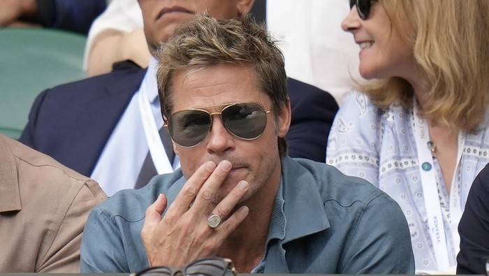 Actor Brad Pitt and director Guy Ritchie sit in the stands on Centre Court for the final of the mens singles between Spains Carlos Alcaraz and Serbias Novak Djokovic on day fourteen of the Wimbledon tennis championships in London, Sunday, July 16, 2023. (AP Photo/Kirsty Wigglesworth)