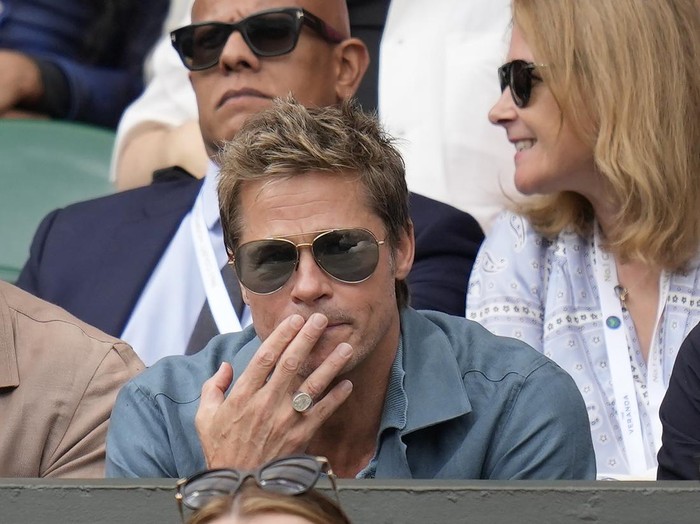 Actor Brad Pitt and director Guy Ritchie sit in the stands on Centre Court for the final of the mens singles between Spains Carlos Alcaraz and Serbias Novak Djokovic on day fourteen of the Wimbledon tennis championships in London, Sunday, July 16, 2023. (AP Photo/Kirsty Wigglesworth)