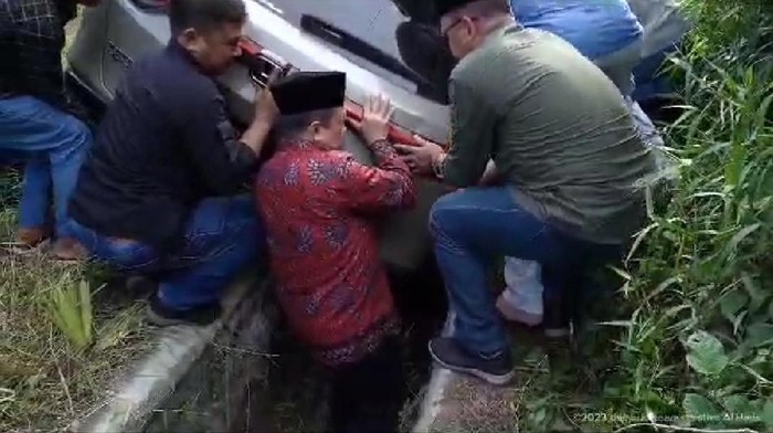 Gubernur Jambi Al Haris masuk got demi mengevakuasi mobil yang terperosok di Jalinsum Jamni.