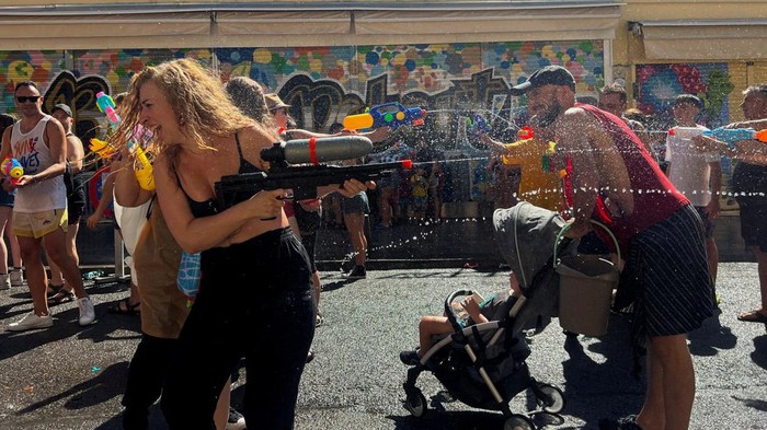Revellers cheer on as a float inaugurates the annual 