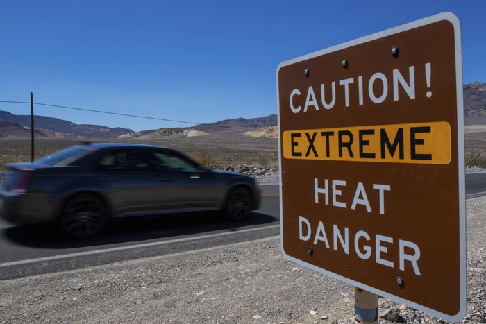 People run to get sunset photos at Zabriskie Point on Saturday, July 8, 2023, in Death Valley National Park, Calif. July is the hottest month at the park with an average high of 116 degrees (46.5 Celsius). (AP Photo/Ty ONeil)