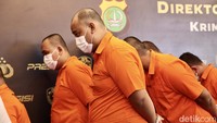 Para tersangka tertunduk saat ditunjukan kepada wartawan. 