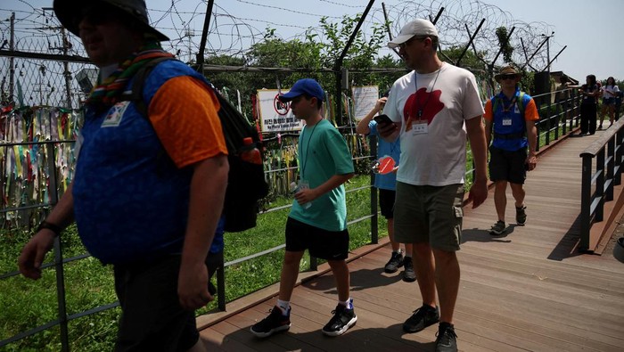 Mengunjungi Zona Demiliterisasi Perbatasan Korea Selatan dan Utara FILE PHOTO: Foreign tourists participating in DMZ tour walk past a military fence near the demilitarized zone separating the two Koreas, in Paju, South Korea July 19, 2023. (REUTERS/Kim Hong-Ji)