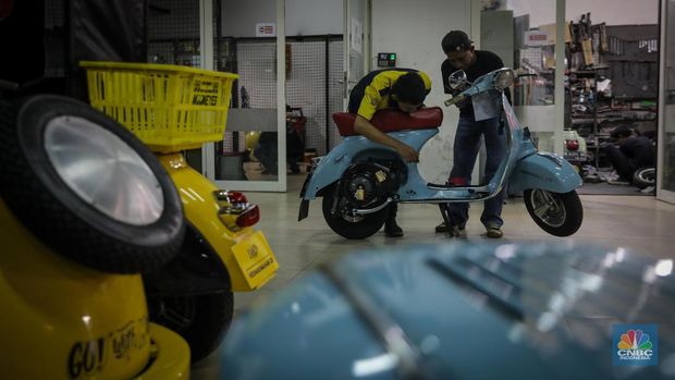 Mekanik mengkonversi vespa klasik dengan bahan bakar minyak (BBM) menjadi vespa tenaga istrik di bengkel Elders Garage, Jakarta, Jumat (21/7/2023).  (CNBC Indonesia/Faisal Rahman)