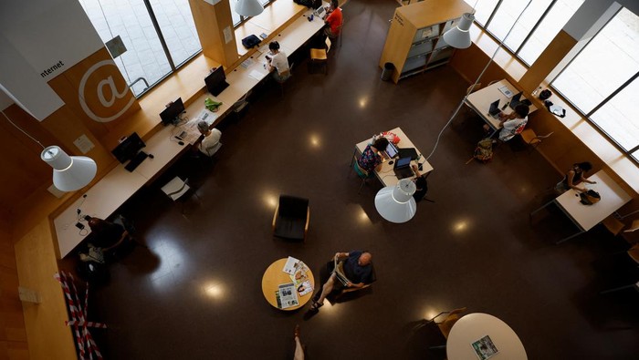 Barcelona's residents sit in a library, designated as the 