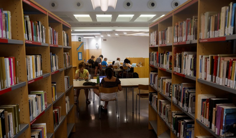 Barcelona's residents sit in a library, designated as the 