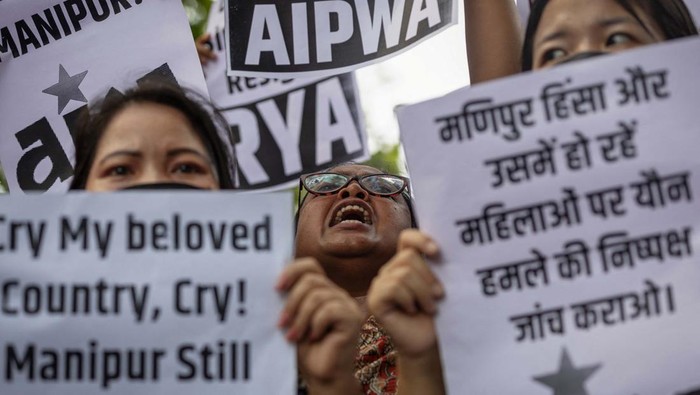 Protestors hold placards as they attend a protest against the alleged sexual assault of two tribal women in the eastern state of Manipur, in New Delhi, India, July 21, 2023. REUTERS/Adnan Abidi
